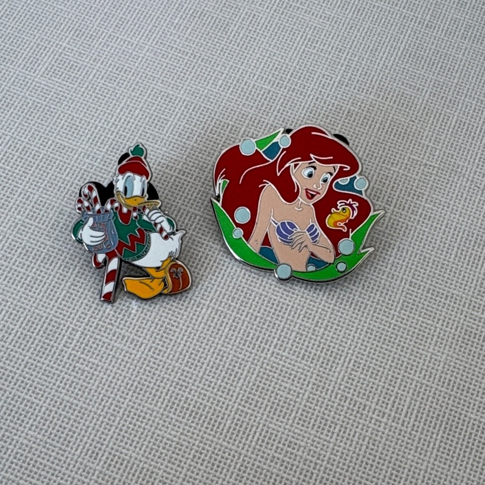 One supercharge Disney Character Enamel pin and one regular